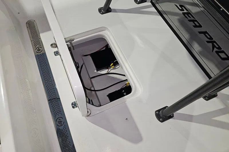 Slide: The Image of 2026 Sea Pro 250 Bay boat interior with open hatch and visible wiring. - 10