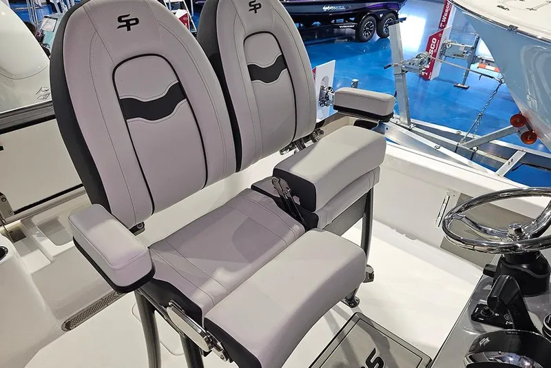 Slide: The Image of 2026 Sea Pro 250 Bay boat seats with armrests and steering wheel. - 13