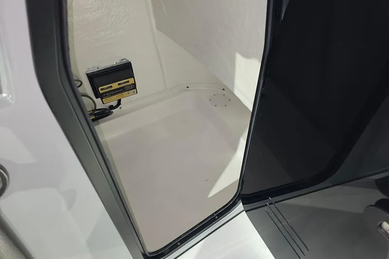 Slide: The Image of 2026 Sea Pro 250 Bay interior compartment with electronic equipment. - 17