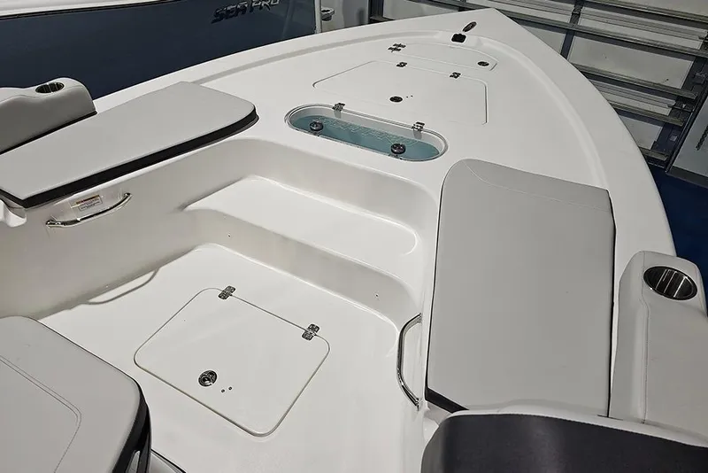 Slide: The Image of 2026 Sea Pro 250 Bay boat interior with seating and storage compartments. - 18