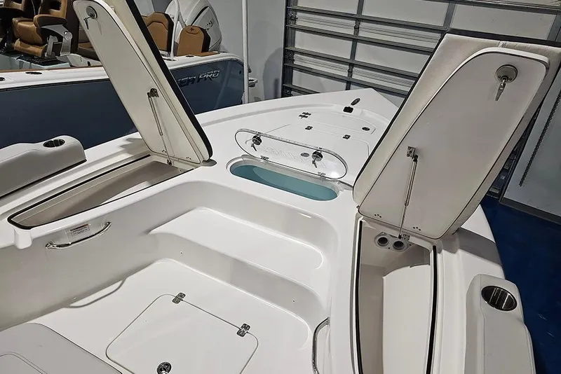 Slide: The Image of 2026 Sea Pro 250 Bay boat interior with open storage compartments and seating. - 19