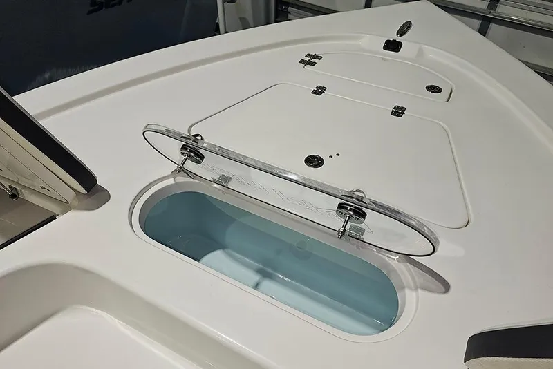 Slide: The Image of 2026 Sea Pro 250 Bay boat with open storage compartment and clear lid. - 20