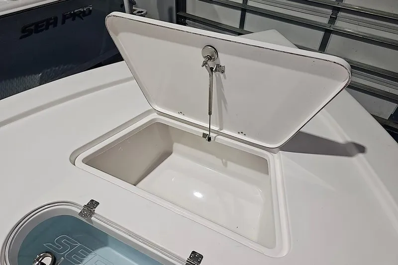 Slide: The Image of Open storage compartment on 2026 Sea Pro 250 Bay boat. - 21