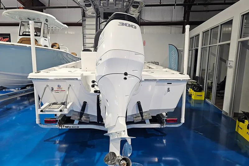 Slide: The Image of 2026 Sea Pro 250 Bay boat with powerful outboard motor in showroom. - 4