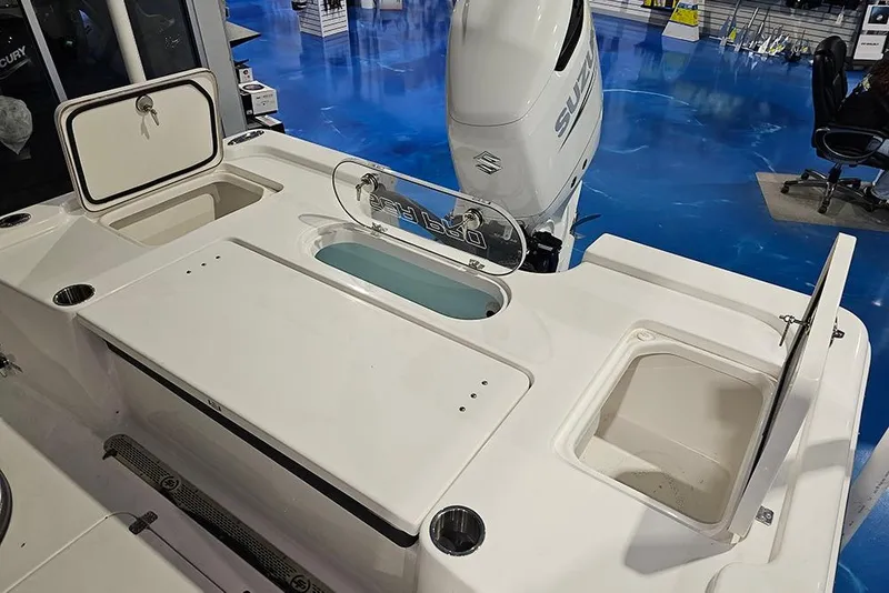 Slide: The Image of 2026 Sea Pro 250 Bay boat deck with storage compartments and Suzuki outboard motor. - 6