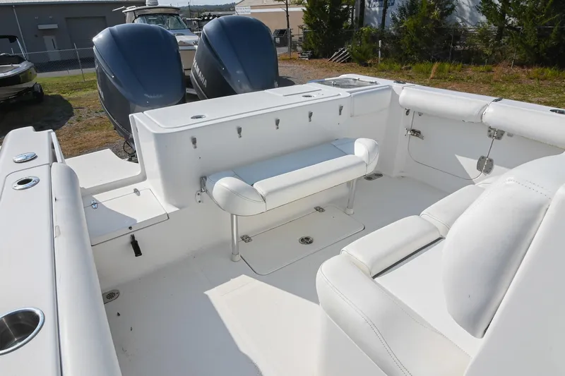 Slide: The Image of 2015 Sea Hunt Gamefish 30 boat interior with seating and dual Yamaha engines. - 12