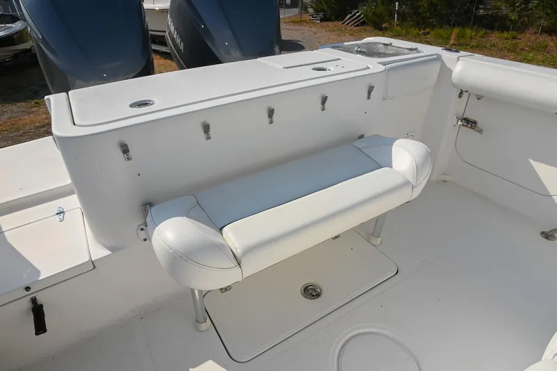 Slide: The Image of 2015 Sea Hunt Gamefish 30 boat interior with white seating and storage compartments. - 13