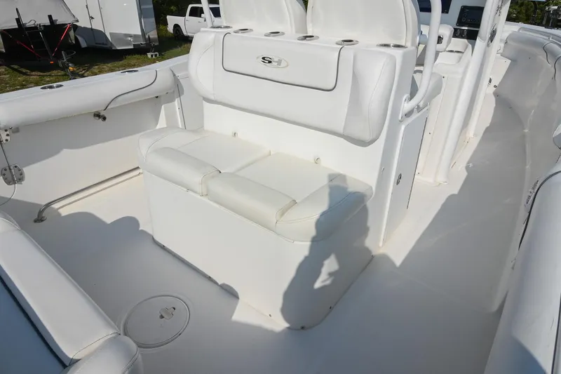 Slide: The Image of 2015 Sea Hunt Gamefish 30 boat interior with white seating and storage compartments. - 14