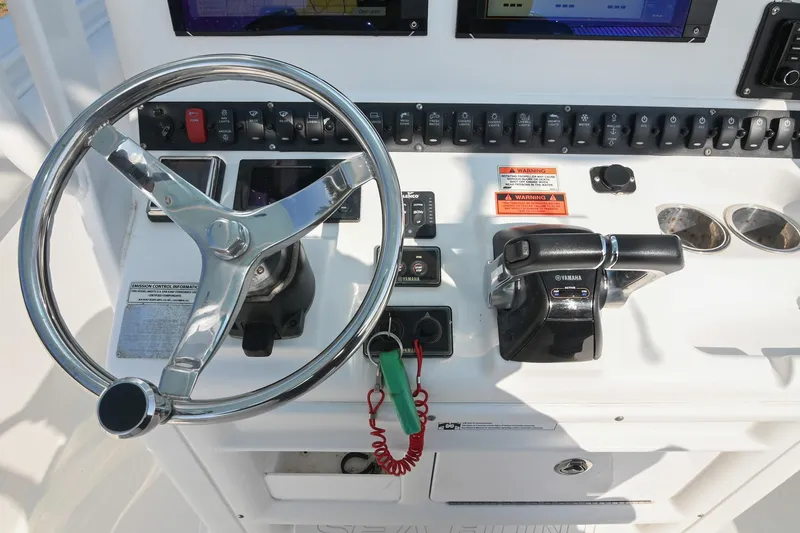 Slide: The Image of Control panel of 2015 Sea Hunt Gamefish 30 boat with steering wheel and throttle. - 19