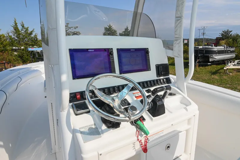 Slide: The Image of 2015 Sea Hunt Gamefish 30 boat console with dual screens and steering wheel. - 20