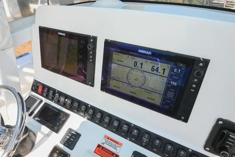 Slide: The Image of 2015 Sea Hunt Gamefish 30 dashboard with Simrad navigation displays and control panel. - 21