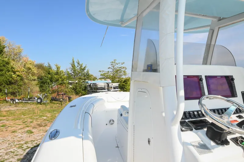Slide: The Image of 2015 Sea Hunt Gamefish 30 boat with modern dashboard, parked outdoors. - 25
