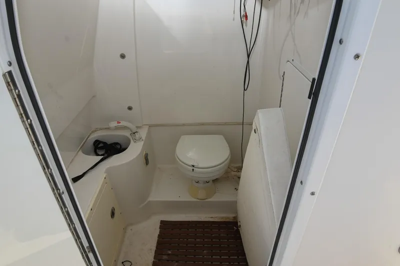 Slide: The Image of 2015 Sea Hunt Gamefish 30 boat interior with toilet and storage area. - 28