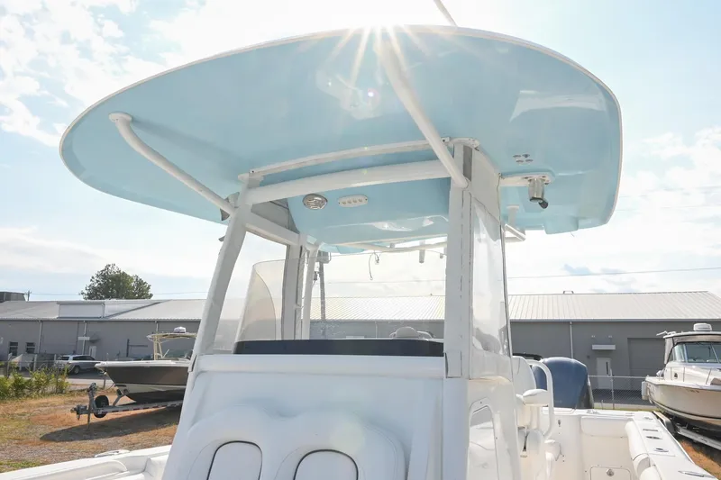 Slide: The Image of 2015 Sea Hunt Gamefish 30 boat with blue T-top under sunny sky. - 29