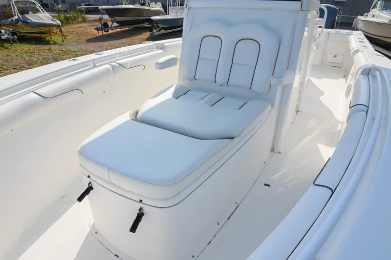 Slide: The Image of 2015 Sea Hunt Gamefish 30 boat interior with white cushioned seating. - 32