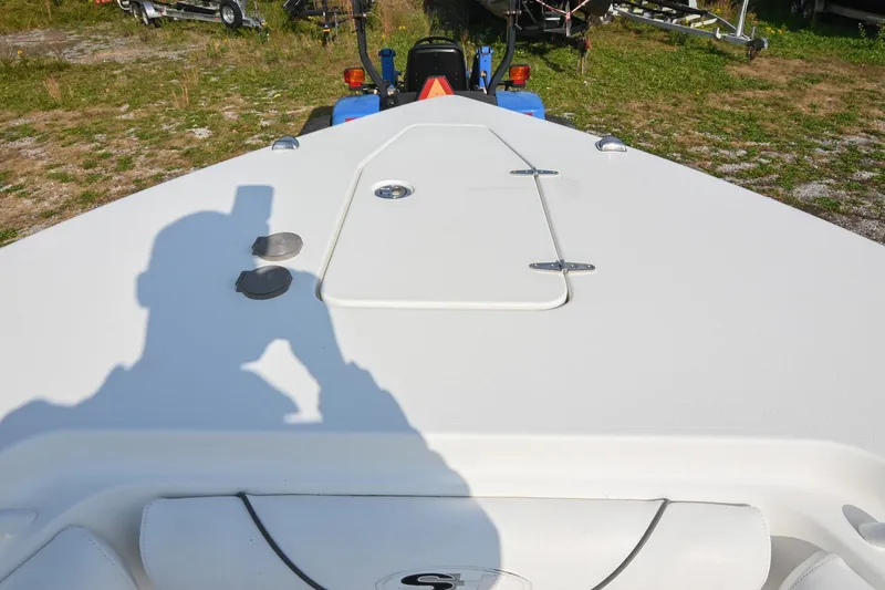 Slide: The Image of 2015 Sea Hunt Gamefish 30 boat deck with shadow and hatch, parked on grass. - 35