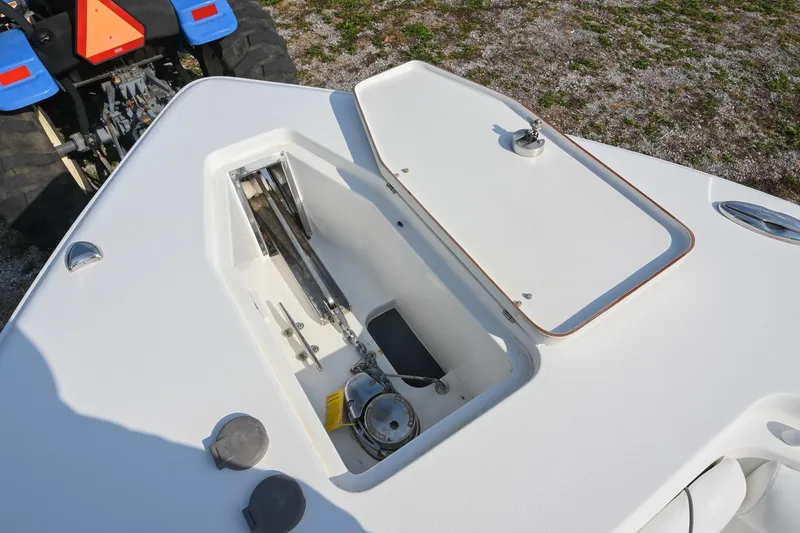 Slide: The Image of 2015 Sea Hunt Gamefish 30 anchor compartment with open hatch, showing anchor chain and winch. - 36