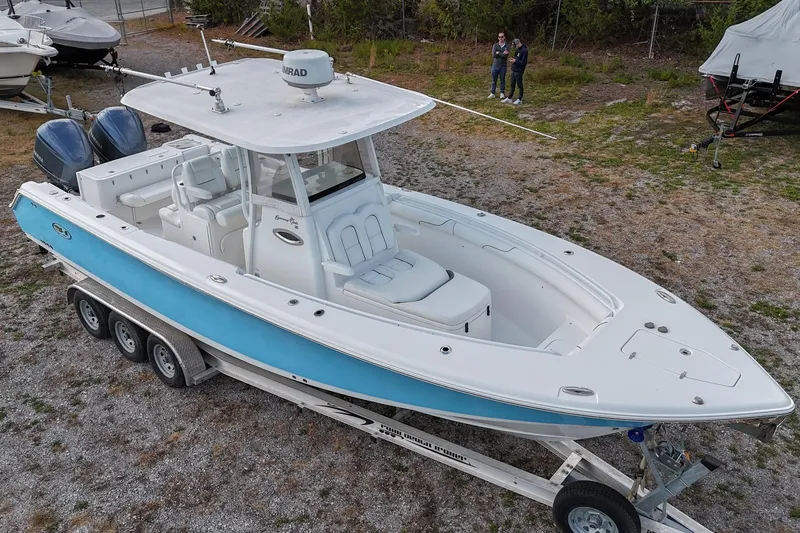 Slide: The Image of 2015 Sea Hunt Gamefish 30 boat on trailer, featuring dual engines and spacious deck. - 37
