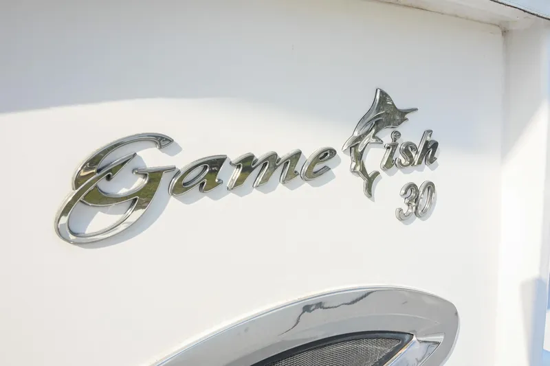 Slide: The Image of 2015 Sea Hunt Gamefish 30 logo on white boat surface. - 8