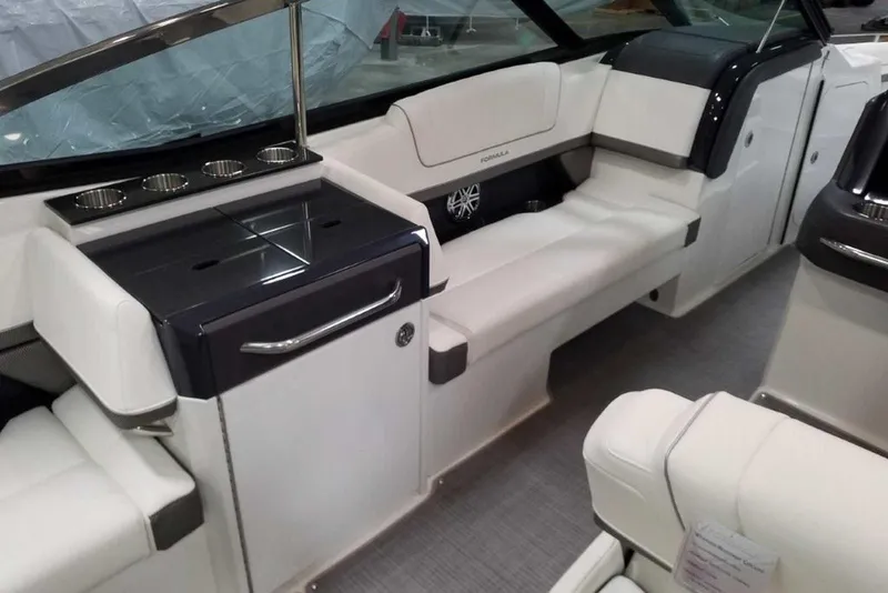 Slide: The Image of Storage compartment in 2019 Formula 330 Crossover Bowrider with life jackets and safety gear. - 20
