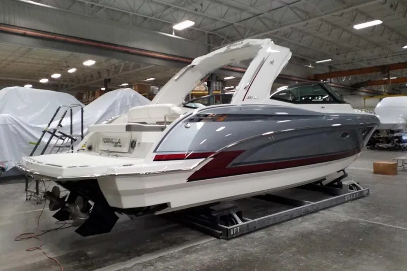 Slide: The Image of 2019 Formula 330 Crossover Bowrider with sleek design and vibrant red accents. - 3