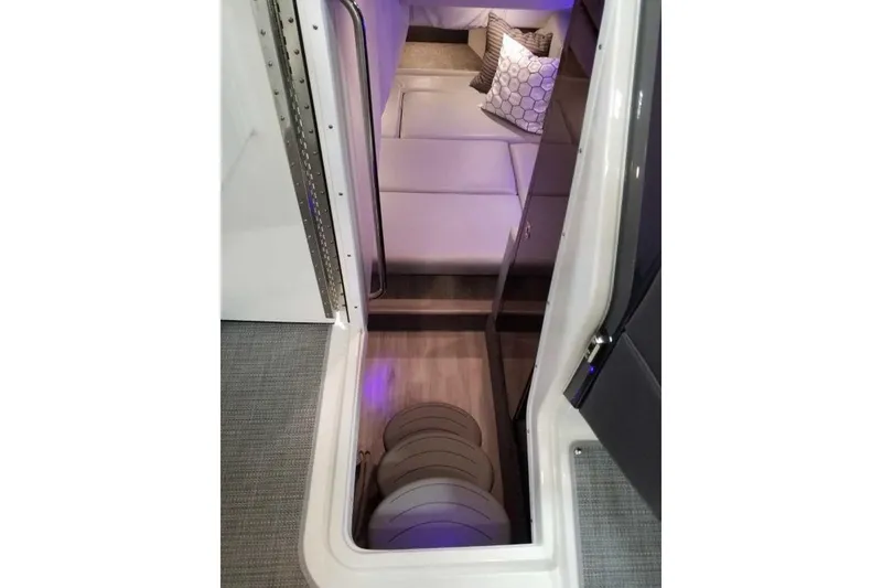 Slide: The Image of 2019 Formula 330 Crossover Bowrider interior with white seating and speaker system. - 33