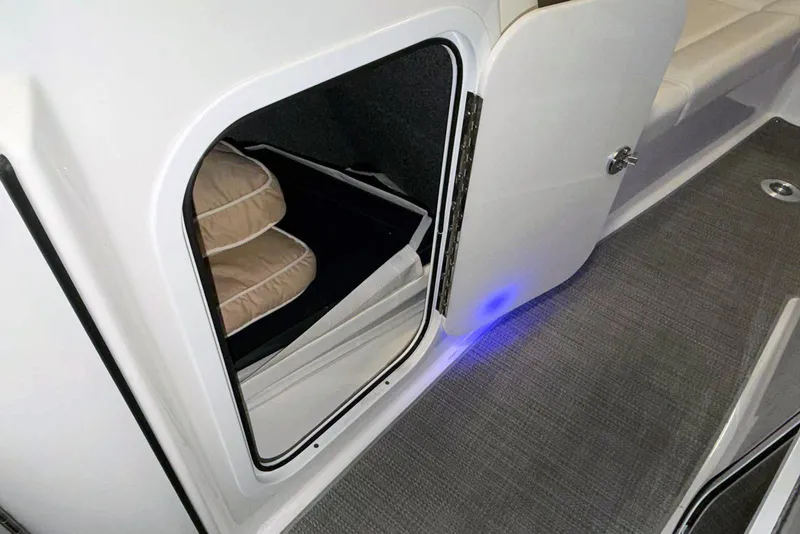 Slide: The Image of 2019 Formula 330 Crossover Bowrider cabin storage with cushions and blue LED lighting. - 40
