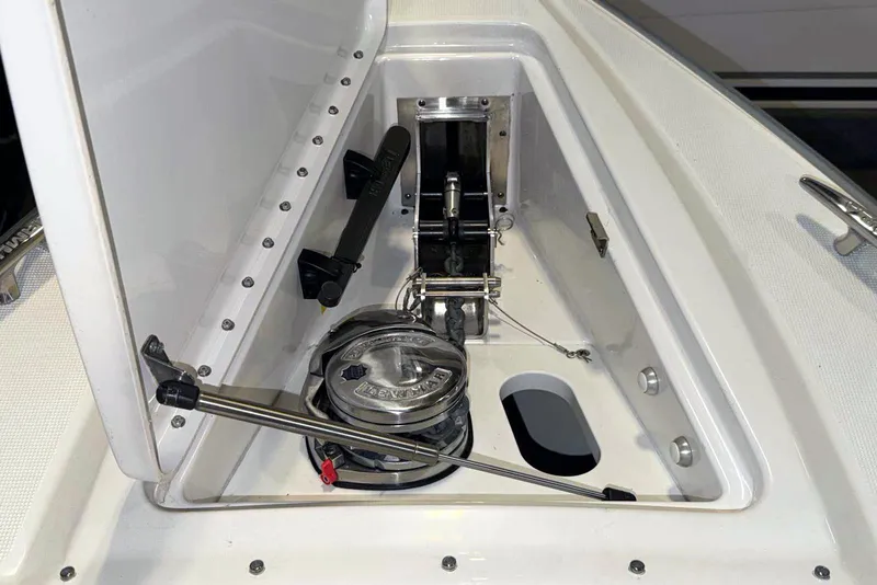 Slide: The Image of 2019 Formula 330 Crossover Bowrider anchor compartment with winch and hardware. - 51
