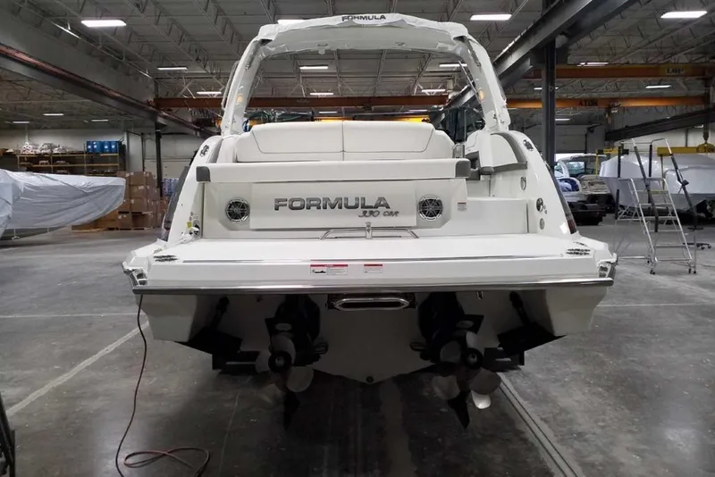 Slide: The Image of 2019 Formula 330 Crossover Bowrider boat in storage, supported by stands. - 6