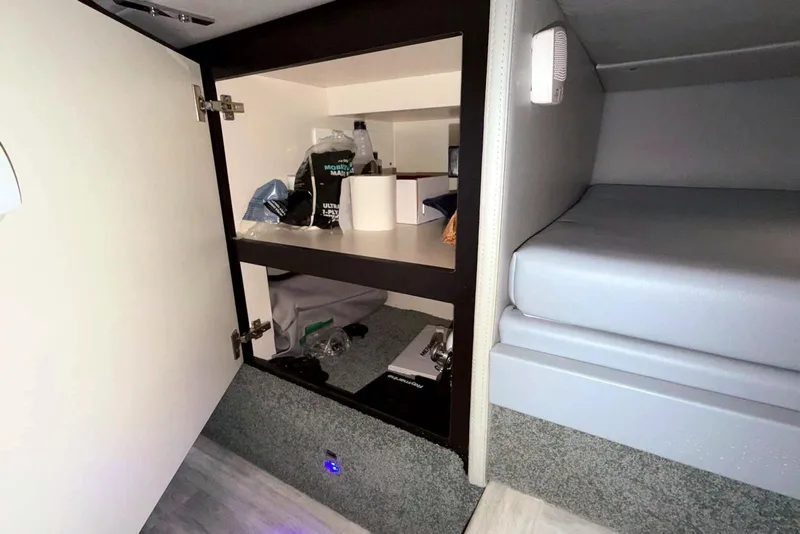 Slide: The Image of Interior storage of 2019 Formula 330 Crossover Bowrider with shelves and items. - 61
