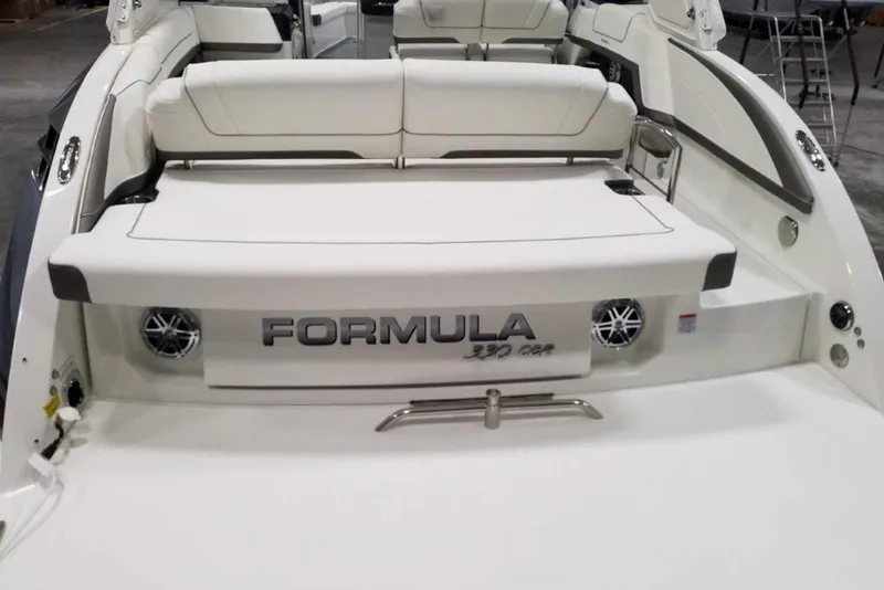 Slide: The Image of 2019 Formula 330 Crossover Bowrider with MerCruiser Bravo Three outdrives in a garage. - 7