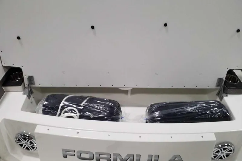 Slide: The Image of 2019 Formula 330 Crossover Bowrider in storage, covered, with visible swim platform. - 9