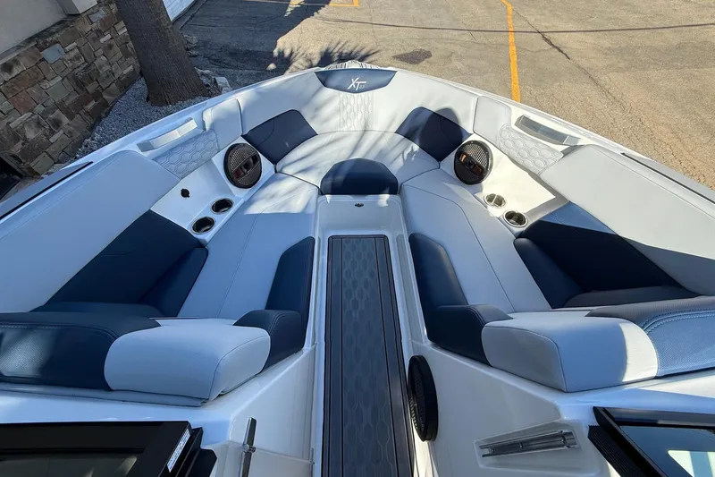 Slide: The Image of 2023 MasterCraft XT23 boat interior with luxurious seating and modern design. - 13