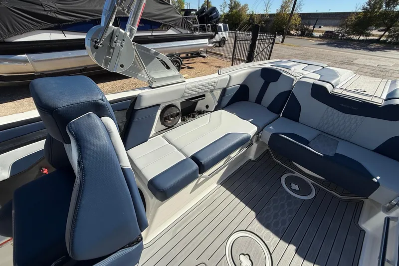 Slide: The Image of 2023 MasterCraft XT23 boat interior with blue and gray seating, modern design. - 15