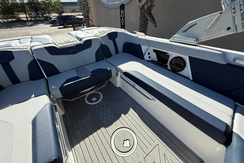 Slide: The Image of 2023 MasterCraft XT23 boat interior with sleek seating and modern design. - 16