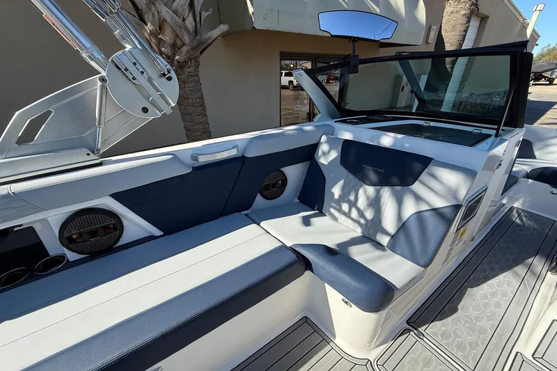Slide: The Image of 2023 MasterCraft XT23 boat interior with blue and white seating, modern design. - 8