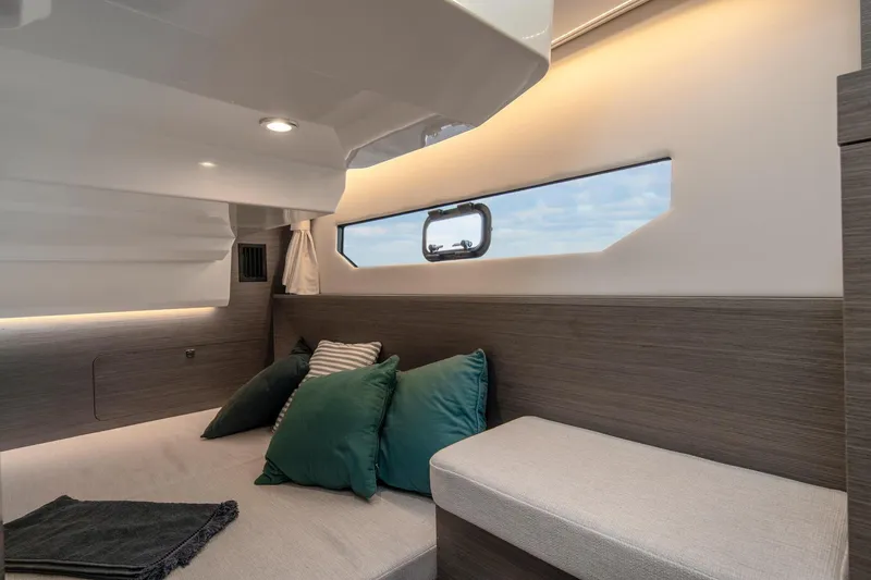 Slide: The Image of Interior of 2025 Jeanneau NC895 S2 boat, featuring cozy seating and modern design. - 6