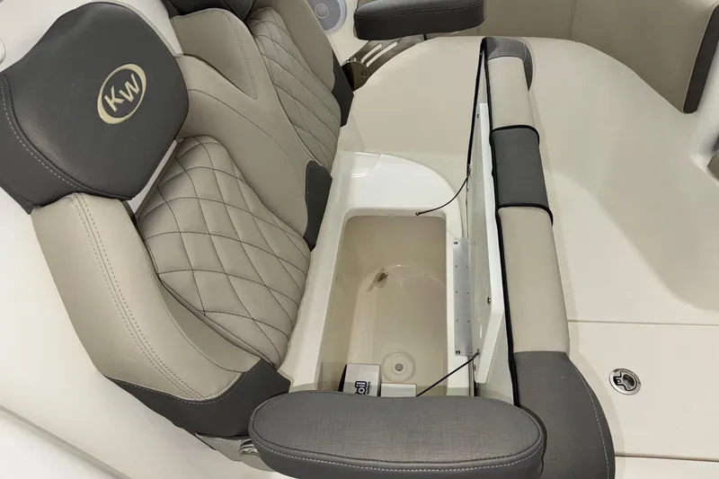 Slide: The Image of 2025 Key West 263 FS boat interior with cushioned seating and storage compartment. - 11