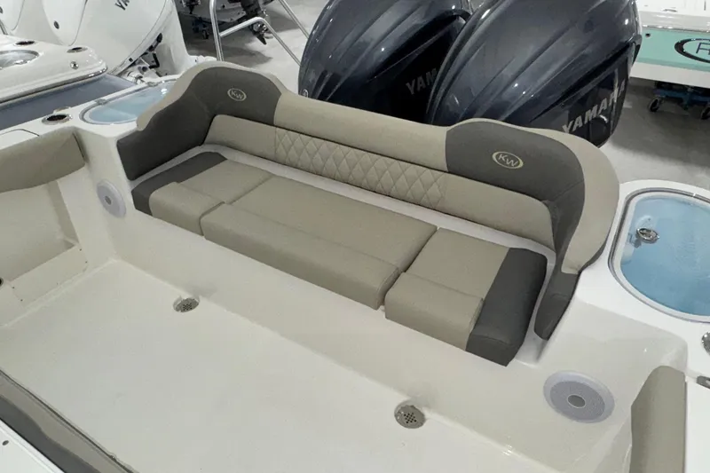Slide: The Image of 2025 Key West 263 FS boat interior with cushioned seating and Yamaha engines. - 19
