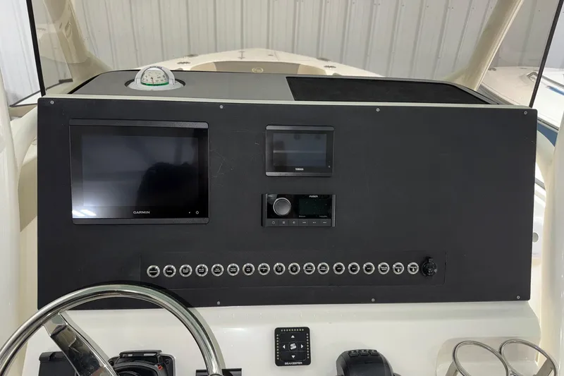 Slide: The Image of 2025 Key West 263 FS boat dashboard with Garmin and Yamaha displays, steering wheel, and controls. - 26