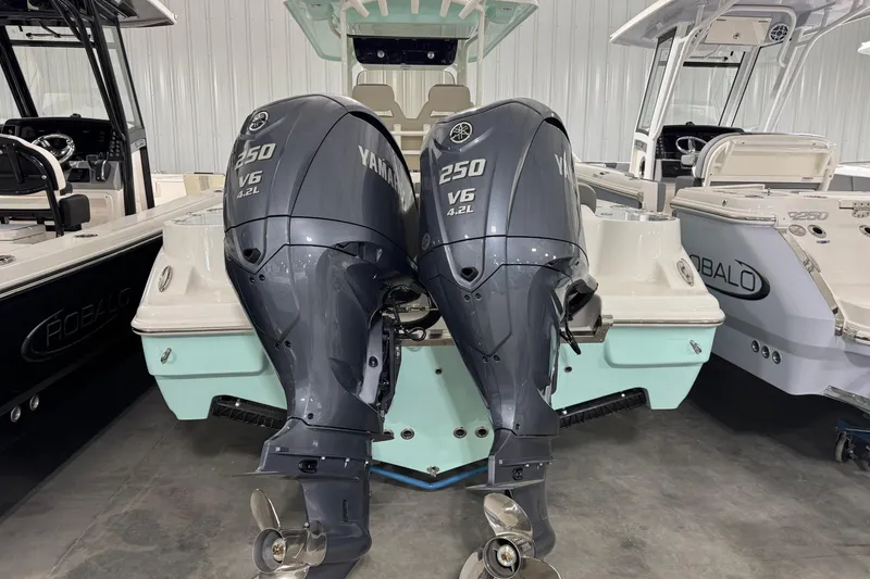 Slide: The Image of 2025 Key West 263 FS boat with twin Yamaha 250 V6 outboard engines in a showroom. - 4