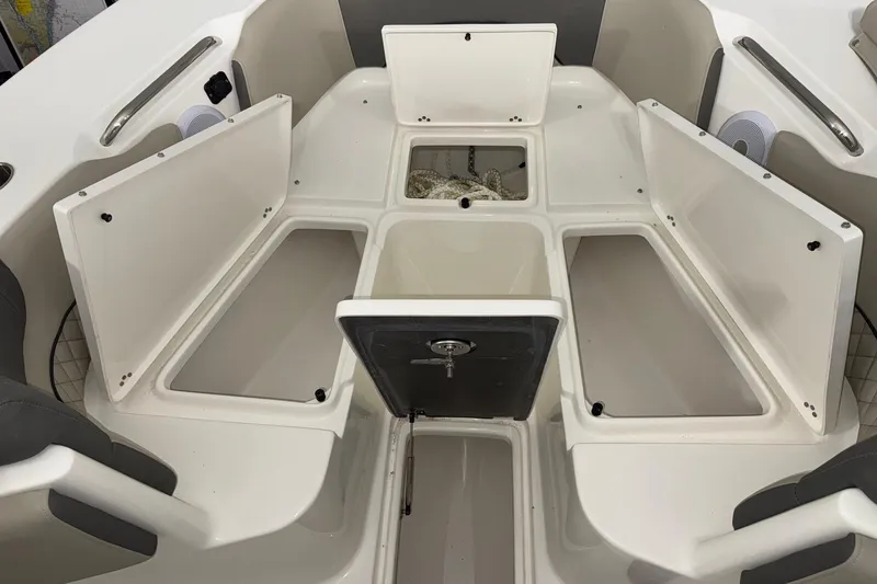 Slide: The Image of 2025 Key West 263 FS boat interior with open storage compartments and seating. - 9