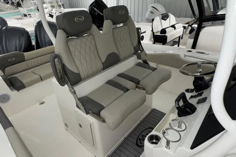 Slide: The Image of 2025 Key West 263 FS boat interior with dual seats and modern helm controls. - 12
