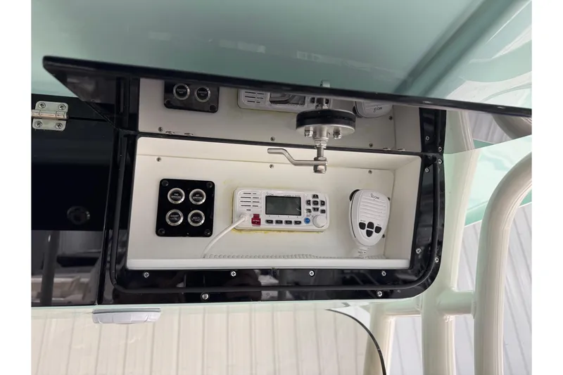 Slide: The Image of 2025 Key West 263 FS boat console with electronic controls and communication devices. - 25