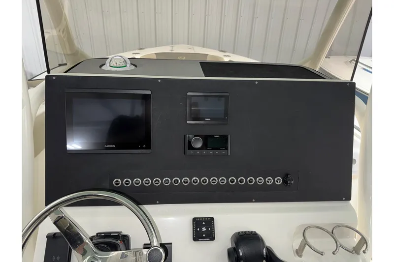 Slide: The Image of 2025 Key West 263 FS boat dashboard with Garmin display and controls. - 26