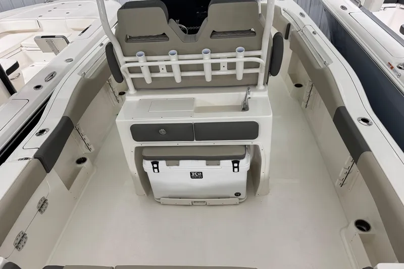 Slide: The Image of 2025 Key West 263 FS boat interior with seating, rod holders, and storage. - 6