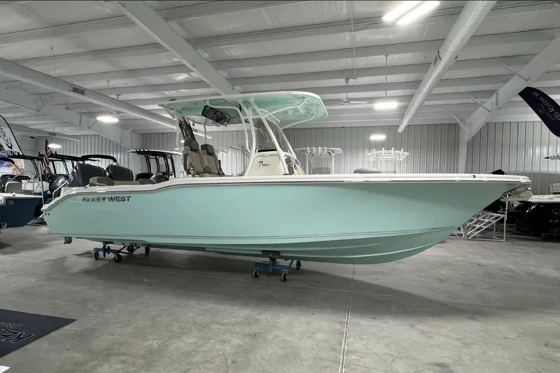 The Image of 2025 Key West 263 FS boat in showroom, light blue hull, modern design. - 1