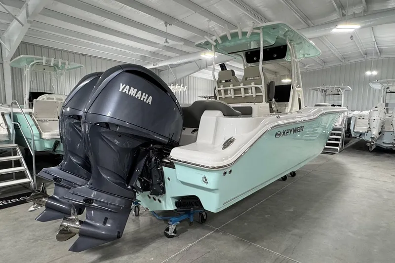 Slide: The Image of 2025 Key West 263 FS boat with dual Yamaha engines in a showroom. - 3