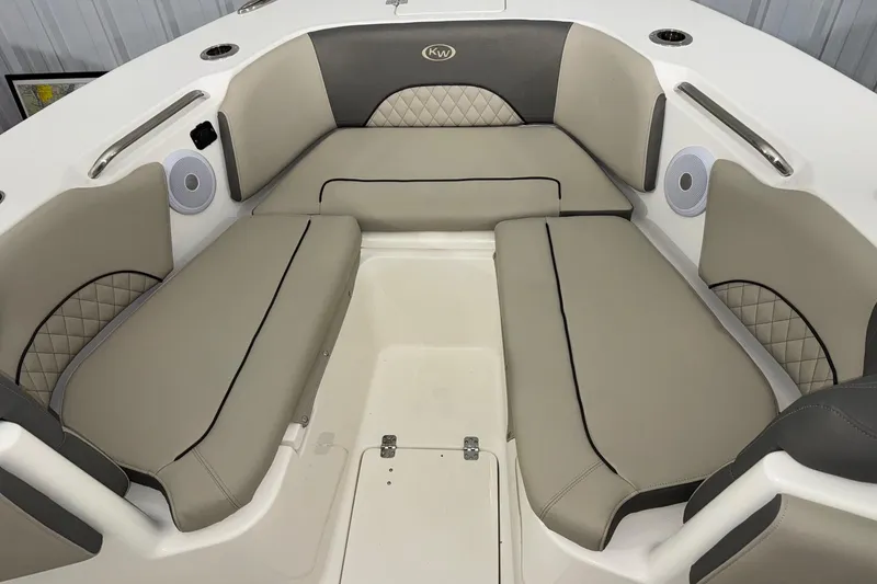 Slide: The Image of 2025 Key West 263 FS boat interior with beige cushioned seating and built-in speakers. - 8