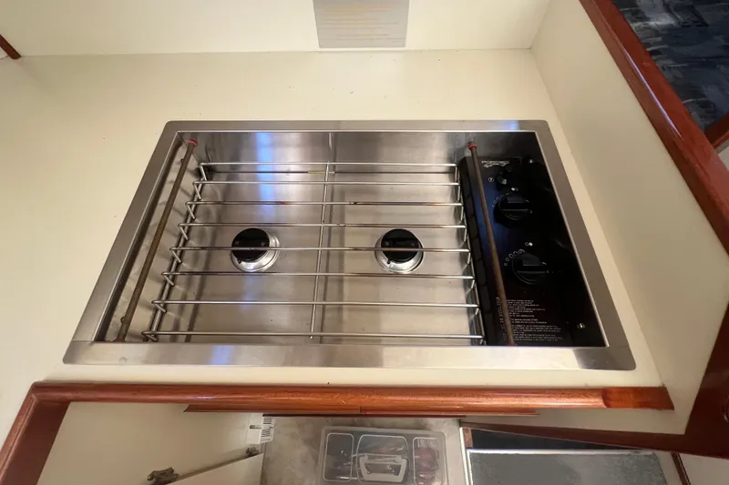 Slide: The Image of 2005 Camano Trawler kitchen stove with two burners and control knobs. - 17